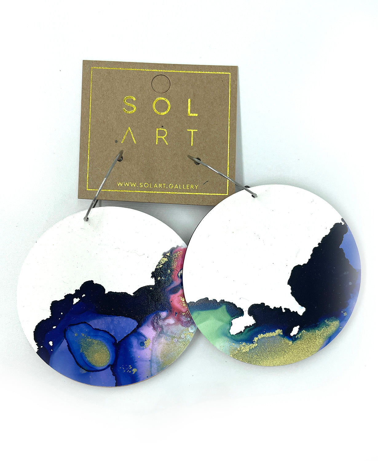 Shop women's wooden earrings named 'White Beauty Statement shaped as a disc. Painted with inks on Yupo paper with stainless steel hoops. Made in Australia.