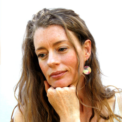 Model shot of women's wooden earrings named ‘Round 25 Sky’ with a round shape. Made from sustainable wood with stainless steel hoops. Made in Australia.